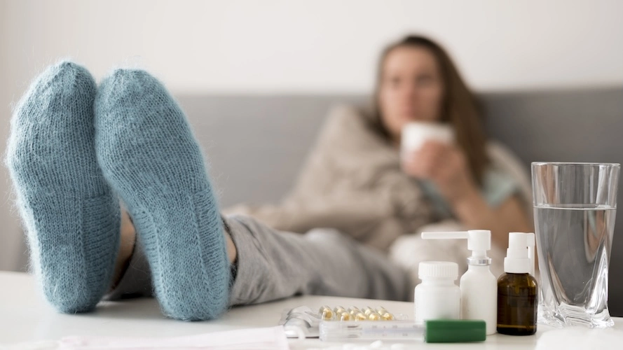 image of a person in socks with feet up on table